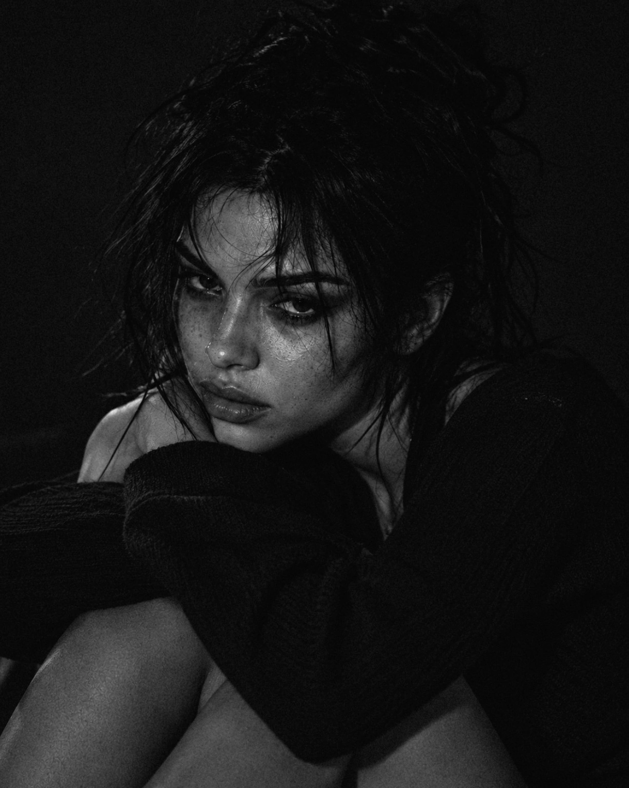 Monochrome portrait of Maxine Meyer resting her chin on a black knit sleeve